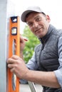 construction worker checking vertical level with measure tool Royalty Free Stock Photo