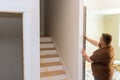 A construction worker checks the evenness the wall with a level