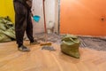 Construction worker is cleaning construction trash in the bags in the toilet room or restroom in apartment that is unde