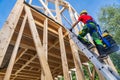 Construction Worker Climbing to Second Level Using Ladder