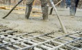Construction worker pouring Concrete during commercial concreting floors of buildings in construction site and Civil Engineer, Royalty Free Stock Photo