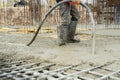 Construction worker pouring Concrete during commercial concreting floors of buildings in construction site and Civil Engineer, Royalty Free Stock Photo