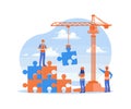 Construction worker connecting puzzle pieces using a crane. Royalty Free Stock Photo