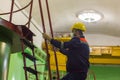 Construction worker on construction site, worker in protective mask, worker in medical mask, construction worker with yellow helme