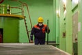 Construction worker on construction site, worker in protective mask, worker in medical mask, construction worker with yellow helme