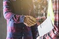 Construction worker and contractor. Client shaking hands with team builder in renovation site Royalty Free Stock Photo