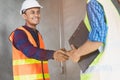 Construction worker and contractor. Client shaking hands with team builder in renovation site Royalty Free Stock Photo