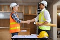 construction worker and contractor. Client shaking hands with team builder in renovation site in the morning Royalty Free Stock Photo