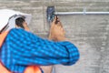 Construction worker and contractor. Electrician prepare to wire electric system on the ceiling in reconstruction room Royalty Free Stock Photo