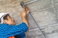 Electrician prepare to wire electric system on the ceiling in reconstruction room Royalty Free Stock Photo