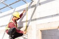 Construction worker or contractor man using measuring tape checking from steel  roof frame to the door Royalty Free Stock Photo