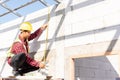 Construction worker or contractor man using measuring tape checking from steel  roof frame to the door Royalty Free Stock Photo