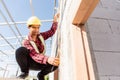 Construction worker or contractor man using measuring tape checking from steel  roof frame to the door Royalty Free Stock Photo