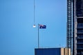 Construction worker in a crane gondola near the Australia flag Royalty Free Stock Photo