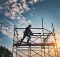 construction worker cunstruct scaffolding, silhueete, sunset. AI Image generated. Royalty Free Stock Photo