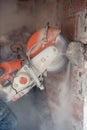 construction worker cutting concrete with a professional concrete chainsaw Royalty Free Stock Photo