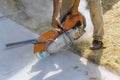 Construction worker cutting concrete sidewalk using a diamond saw blade Royalty Free Stock Photo