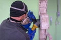 Construction worker cutting concrete wall by using electric cutter Royalty Free Stock Photo