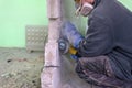 Construction worker cutting concrete wall by using electric cutter Royalty Free Stock Photo