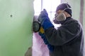 Construction worker cutting concrete wall by using electric cutter Royalty Free Stock Photo