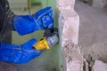 Construction worker cutting concrete wall by using electric cutter. Dangerous work. Royalty Free Stock Photo