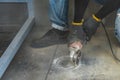 Construction worker is cutting the floor by medium blade machine to circle hold shape with a lot of dust around it for install Royalty Free Stock Photo