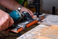 Construction worker cutting laminate using angle grinder with stand for 45 degree. Royalty Free Stock Photo