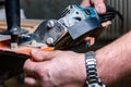 Construction worker cutting laminate using angle grinder with stand for 45 degree. Royalty Free Stock Photo