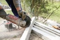 Construction worker cutting a reinforced concrete pillar