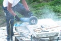 Construction worker is cutting a stone plate with a power cut Royalty Free Stock Photo