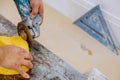 A construction worker cutting a tile using grinder