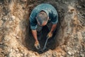 Construction worker digging hole top view Royalty Free Stock Photo