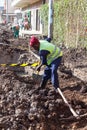 Worker digging a road trench