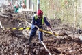 Worker digging a road trench