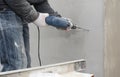 Construction worker drilling a hole in the wall of a house outside Royalty Free Stock Photo