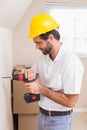 Construction worker drilling hole in wall Royalty Free Stock Photo