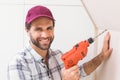 Construction worker drilling hole in wall Royalty Free Stock Photo