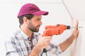Construction worker drilling hole in wall Royalty Free Stock Photo