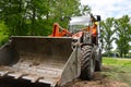 Construction worker drives a small wheel loader on the construction site Royalty Free Stock Photo