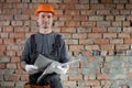 construction worker engineer with hard hat with red brick house renovation construction site plan on wall background Royalty Free Stock Photo