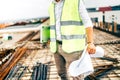 construction worker, engineer wearing safety vest and laptop on construction site