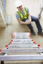 Construction Worker Falling Off Ladder And Injuring Leg Royalty Free Stock Photo