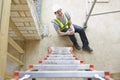 Construction Worker Falling Off Ladder And Injuring Leg Royalty Free Stock Photo