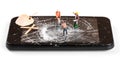 Construction worker figurines repairing broken smartphone screen