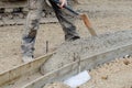 Construction worker filling formwork with wet concrete using shovel Royalty Free Stock Photo