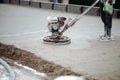 Construction worker finishing concrete screed with power trowel machine, helicopter concrete screed finishing and smoothing