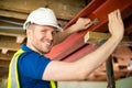 Construction Worker Fitting Steel Support Beam Into Renovated House Ceiling