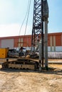 Construction worker Forced the crane to hammer the cement posts into the ground. Construction of industrial plants And the Royalty Free Stock Photo