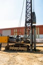 Construction worker Forced the crane to hammer the cement posts into the ground. Construction of industrial plants And the Royalty Free Stock Photo