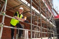 Construction Worker Foreman Builder on Building Site Clipboard and Mug Royalty Free Stock Photo